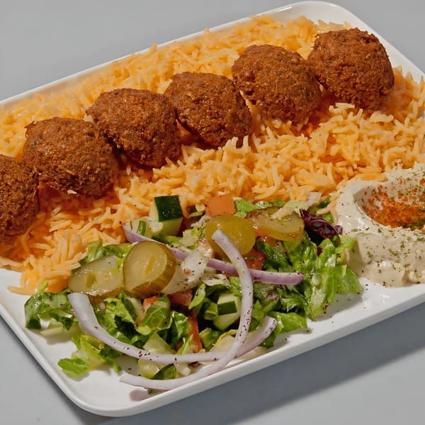 Falafel plate with golden rice, fresh salad, pickles, and hummus, from Pitaville Mediterranean Grill.